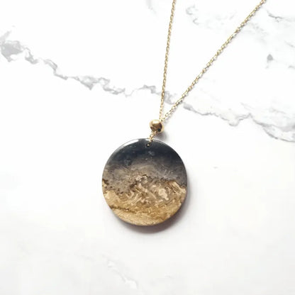 pendentif palmier fossil dore rond MystikBox